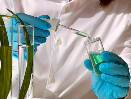 Science and nature concept, green laboratory with researcher inspecting test tubesの写真素材