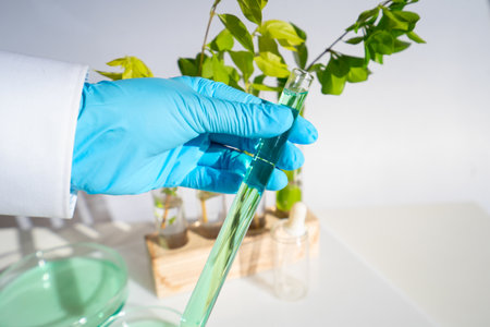 Science and nature concept, green laboratory with researcher inspecting test tubesの写真素材
