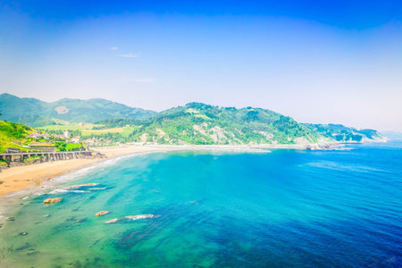 Cantabrian Sea clear water and green coast with Deba town, Pais Vasco Spainの写真素材