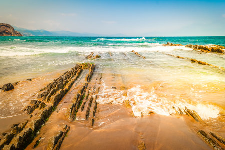 flysch rock formation at Itzurun beach and Cantabrico sea at Zumaia coast, Pais Vasco Spainの写真素材