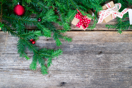 Christmas gift giving and zero waste concept - wrapped christmas gift box, border on wooden backgroundの写真素材