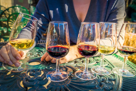 port wine testing, glasses with drink woman holding oneの写真素材