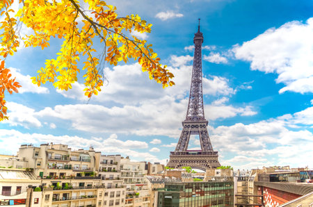 famous Eiffel Tower landmark and Paris roofs with clouds and sunshine, Paris Franceの写真素材