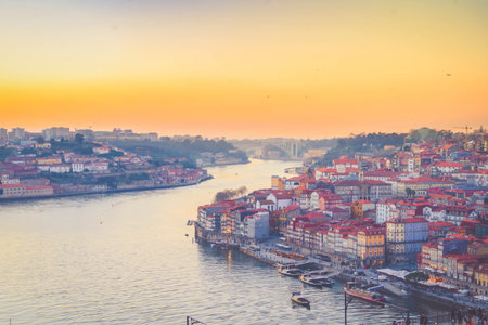 Picturesque, colorful view at old town Porto at sunset, Portugal with bridge Ponte Dom Luis over Douro river. Oporto, touristic mediterranean cityの写真素材