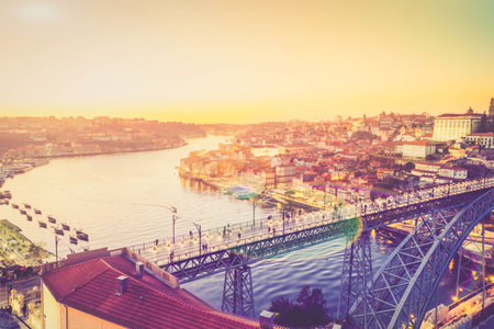 Picturesque, colorful view at old town Porto with famous bridge at night, Portugal with bridge Ponte Dom Luis over Douro river.の写真素材