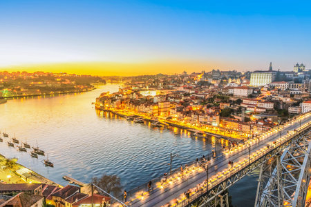 Picturesque, colorful view at old town Porto with famous bridge at night, Portugal with bridge Ponte Dom Luis over Douro river. Oporto, touristic mediterranean cityの写真素材