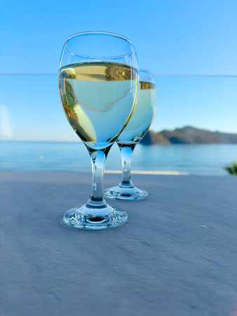 two glasses of cretan wine on Agia Marina beach, Crete Greece, tonedの写真素材