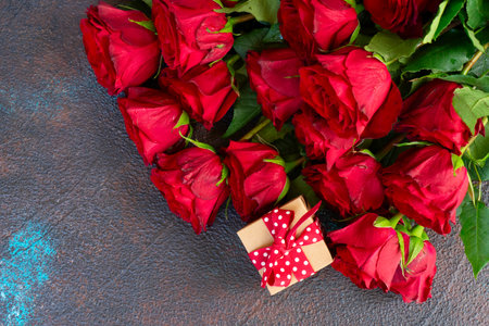 Crimson red rose flowers bouquet with gift box, Valentines Day backgroundの写真素材