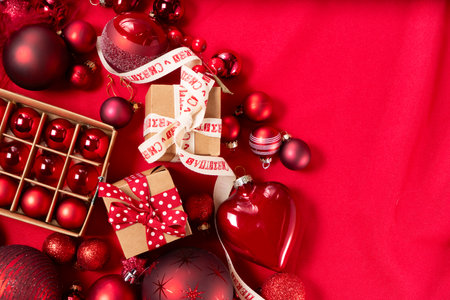 Monochrome red christmas lifestyle - holiday decorations and gift boxes top view border