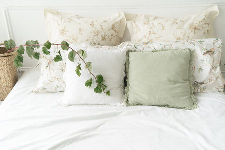 view of bed with white linen and gray pillows close upの写真素材