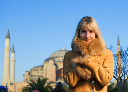 Beautiful blond girl in lambskin coat (Turkey, Istanbul)の写真素材
