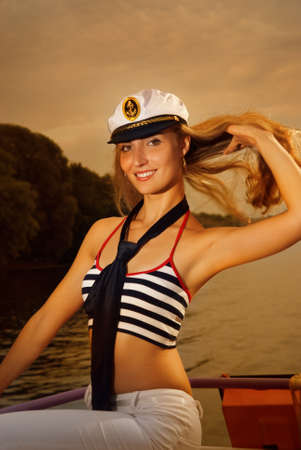  Sexy girl on a yacht at sunset timeの写真素材