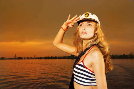 Beautiful girl in captain's hat looking for someone