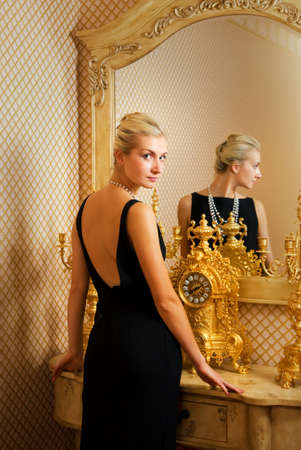 Beautiful blonde girl near luxury the mirrorの写真素材