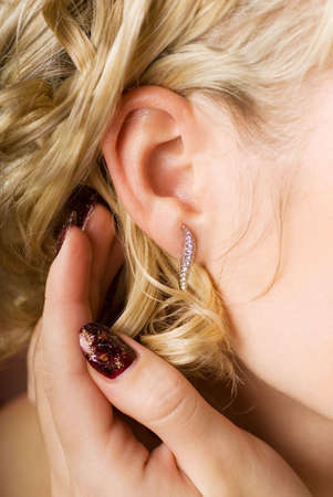 Woman's ear with diamond jewleryの写真素材