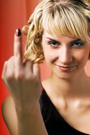 Attractive woman showing middle fingerの写真素材