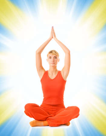 Beautiful young woman doing yoga exercise isolated on abstract backgroundの写真素材