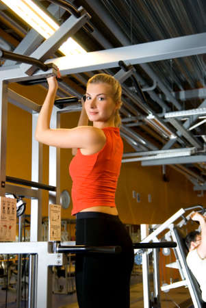 Young beautiful woman pulls herself up