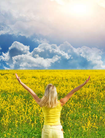 Beautiful young woman in a flower field