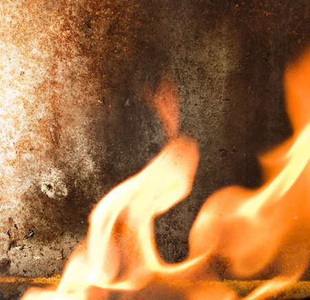 Rusty metal texture and flames of fire around it