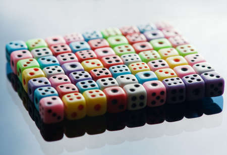 Plastic colorful dices over glass surfaceの写真素材