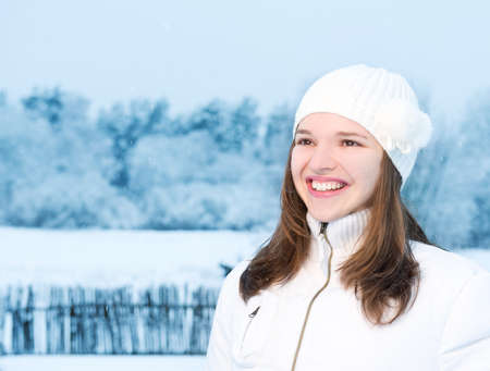 Beautiful young woman in winter clothing outdoorsの写真素材