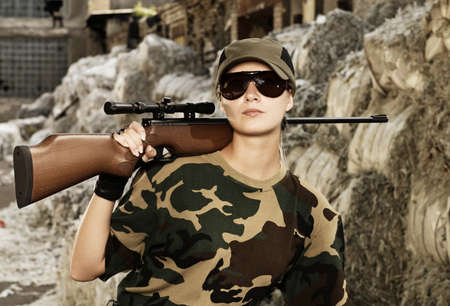 Beautiful woman soldier with a sniper rifle