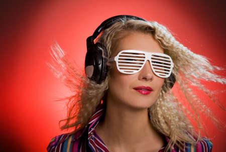 Stylish blond woman with shutter glasses and headphones