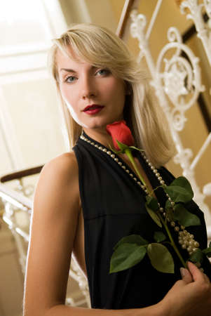 Beautiful young woman with red roseの写真素材