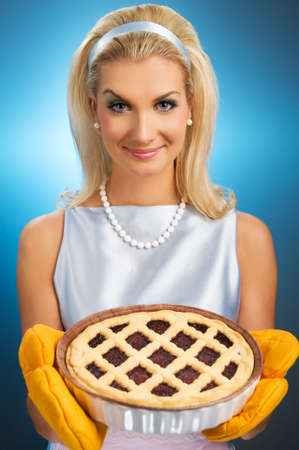 Beautiful woman holding hot italian pie. Retro stylized portraitの写真素材