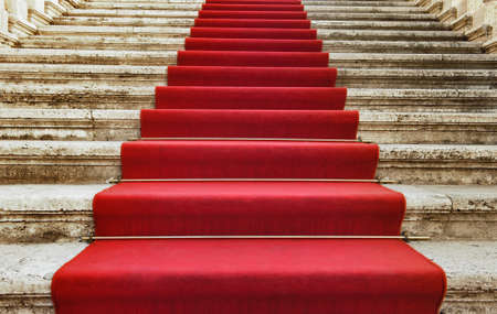 Ancient stairs covered with red carpetの写真素材
