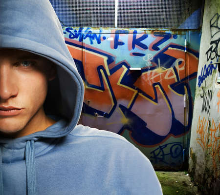 Cool looking hooligan in a graffiti painted gateway Cool looking hooligan in a graffiti painted gateway