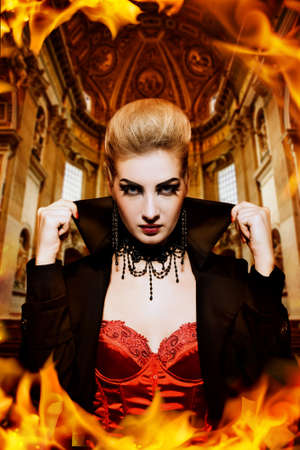 Female vampire in a burning churchの写真素材