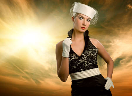 Sexy young woman over sky background. Retro portrait