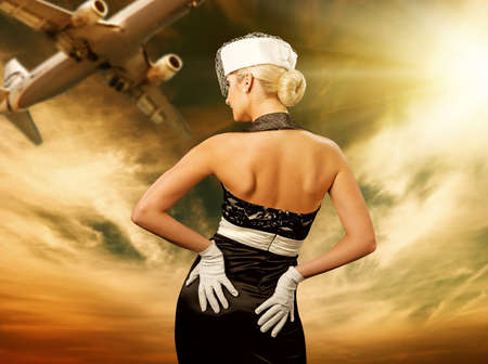 Sexy stewardess and flying planeの写真素材