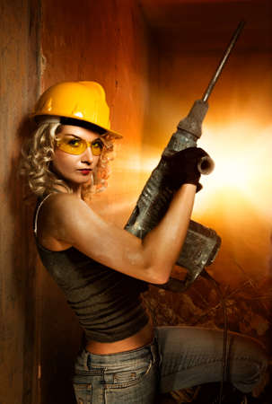 Beautiful blond woman with heavy perforator in her handsの写真素材