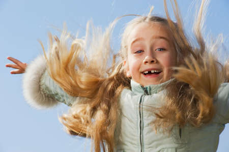 Little girl jumping outdoorsの写真素材