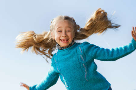 Little girl jumping outdoorsの写真素材