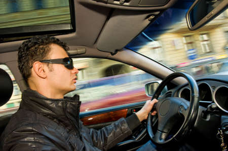 Handsome young man driving a car