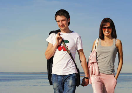 Young couple walking on the beachの写真素材