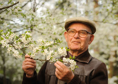 Happy elderly man in a garden