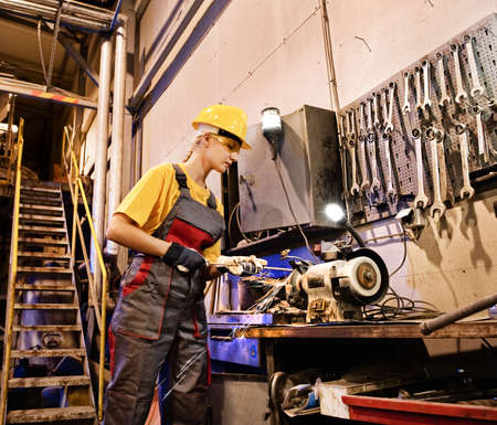 Factory female worker sharpening tools