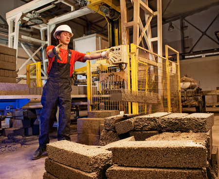 Factory worker throwing defective block