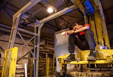 Exhaused factory worker smokingの写真素材