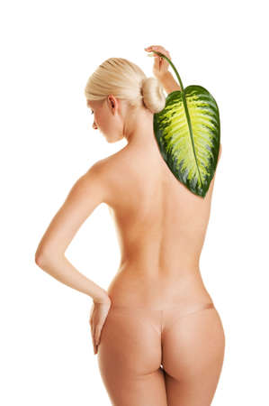 Beautiful young woman with exotic green leaf. Isolated on whiteの写真素材