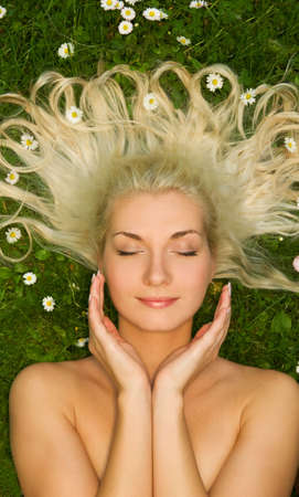 Young woman relaxing on a meadow 

の写真素材