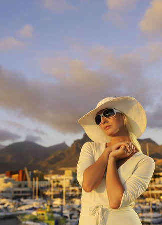 Attractive young woman near the yachtsの写真素材