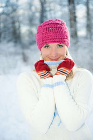 Frozen beautiful woman in winter clothing outdoors

