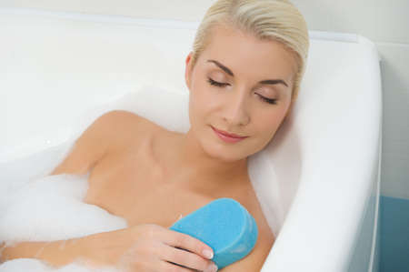 Young woman washing in bathroom 

