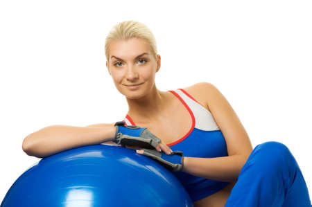 Beautiful fitness trainer with a ballの写真素材